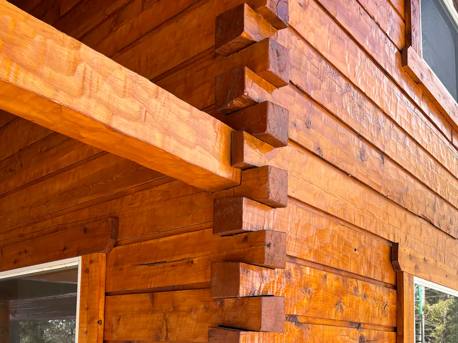A dovetail corner in close-up, the ends of the squared timbers stepping past each other.
